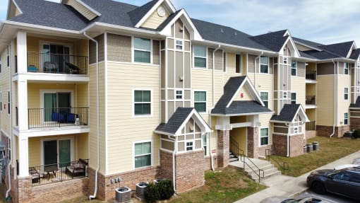 an exterior view of an apartment building with balconies at The Fountains Apartments, Pensacola, Florida, 32514